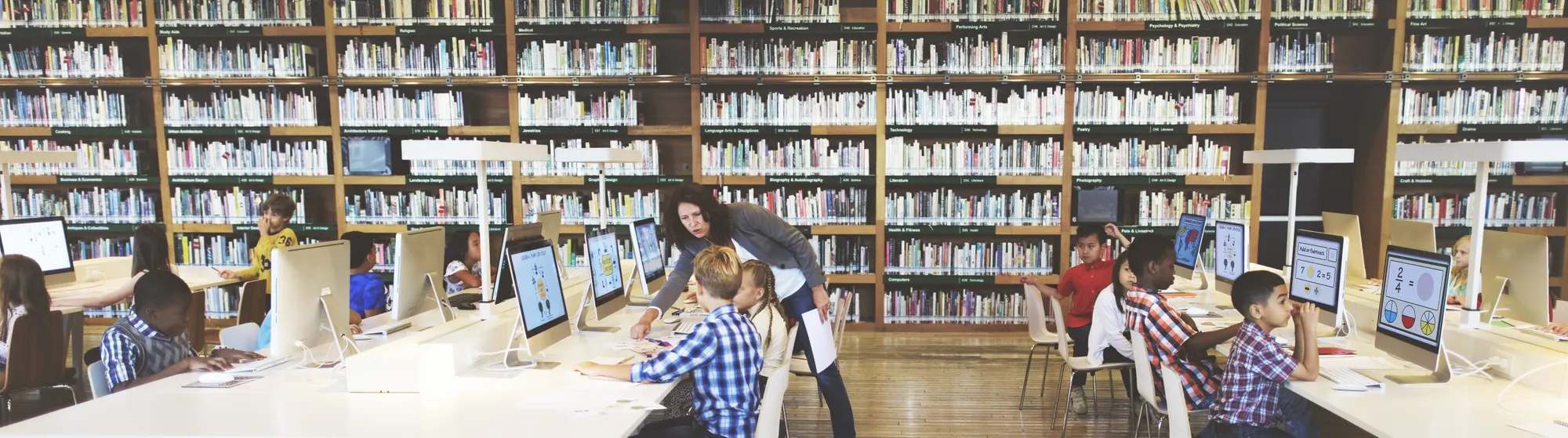 Children on computers in a library.
