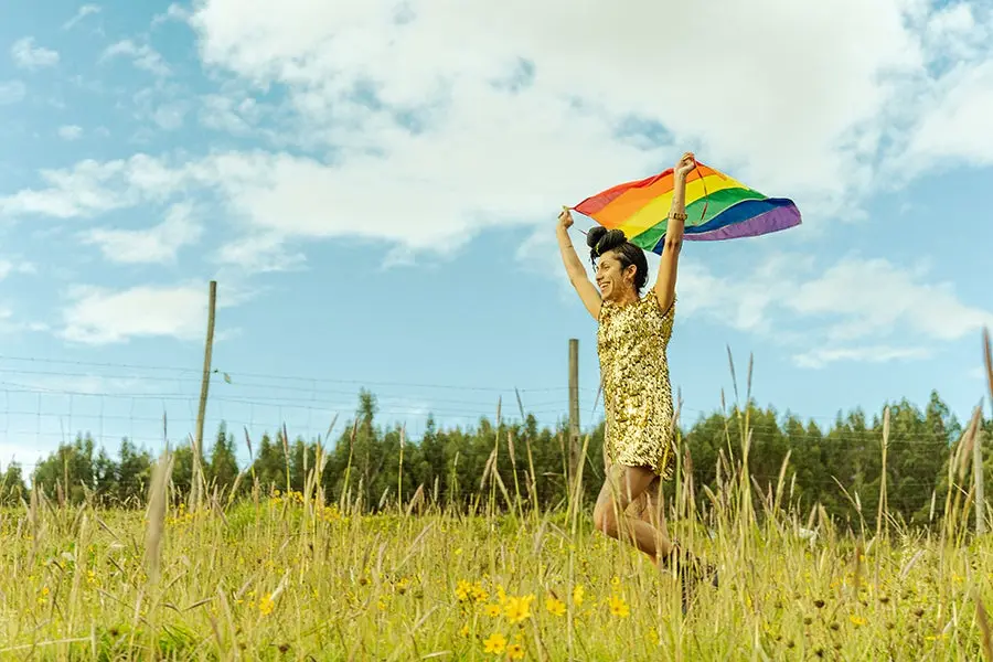 Gerardo Rojas image of transgender person  running with Pride flag