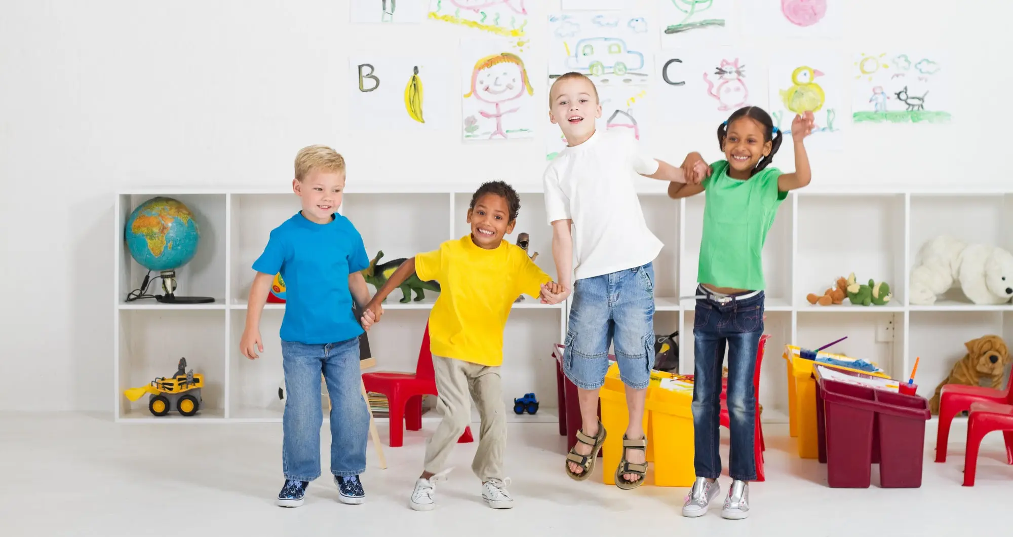 Preschool kids jumping in classroom.