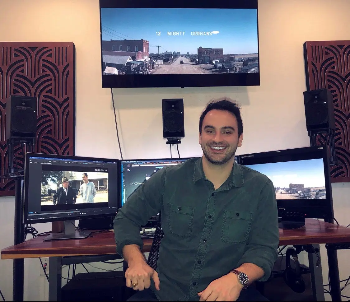 Photo of editor James K. Crouch in front of his screeens where he uses Premier Pro to edit the movie. 