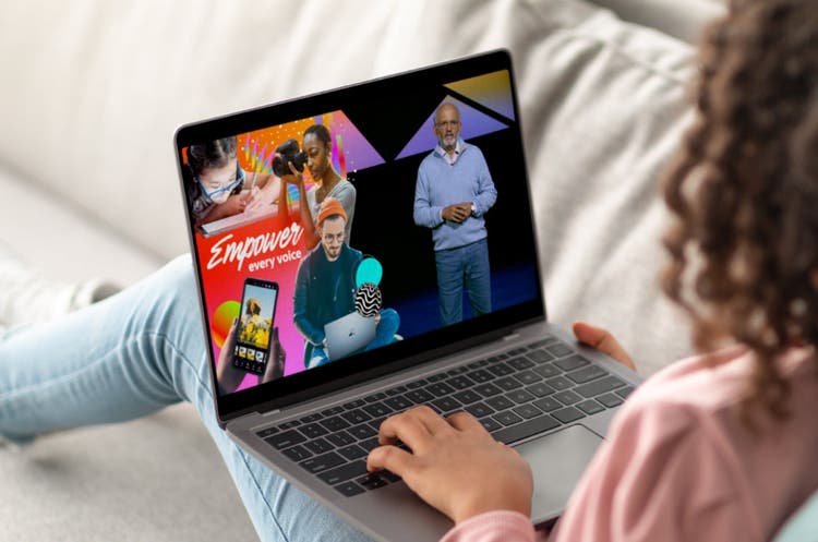 Woman on laptop looking at Adobe Max content.