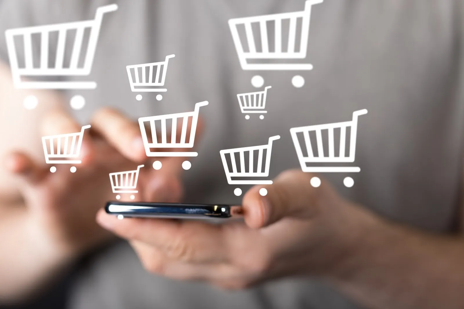 Graphic with shopping carts coming out of a smartphone.