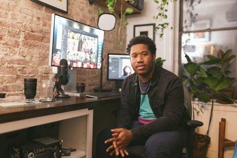 Image of Aundre Larrow in his workspace at home. 