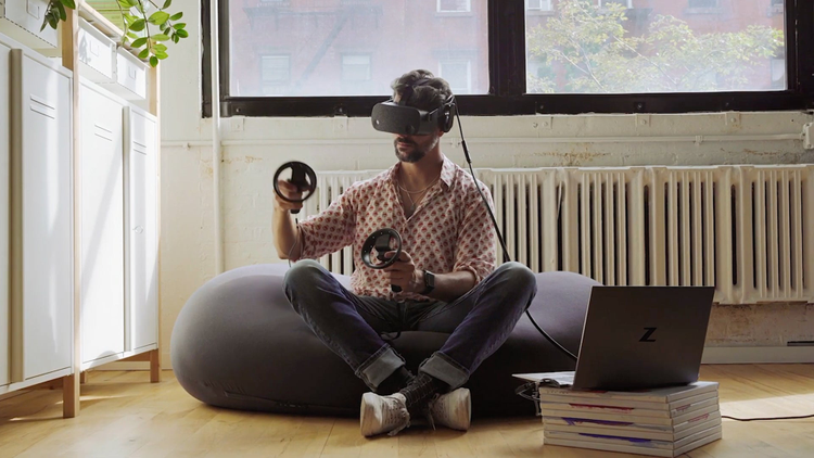 Man playing VR while sitting on a beanbag chair. 