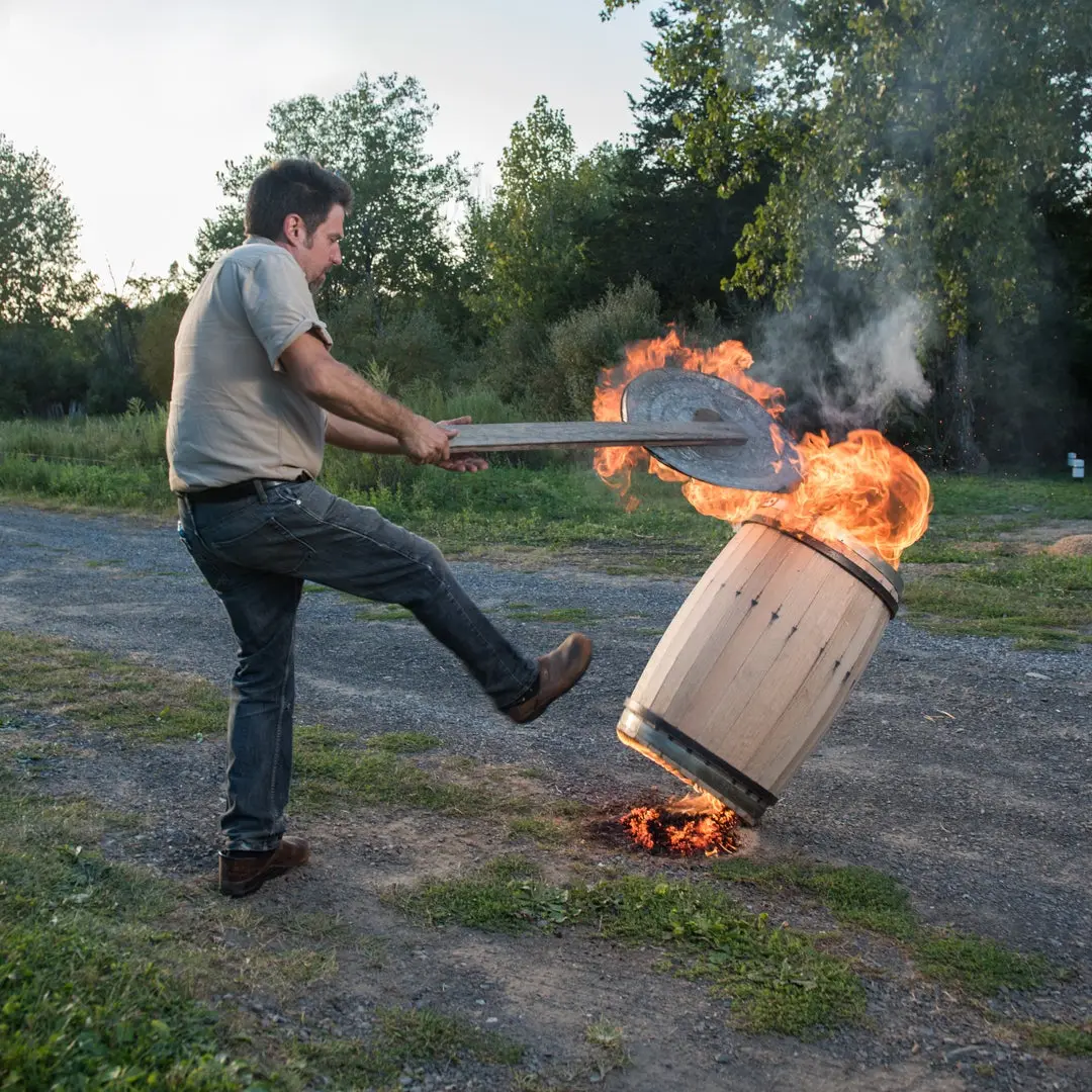 Image of a man hitting a fiery barrel.