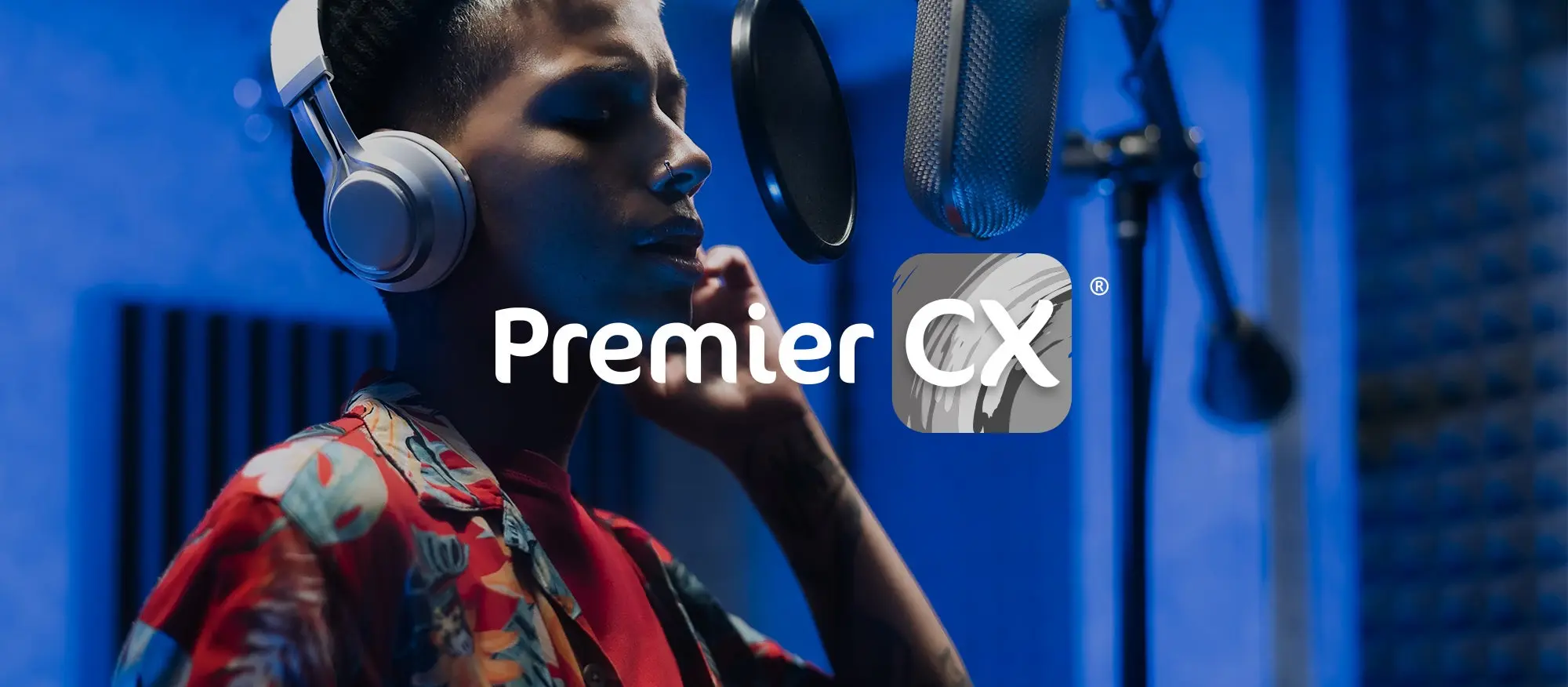 Image of a man in a recording booth with Premier CX logo.