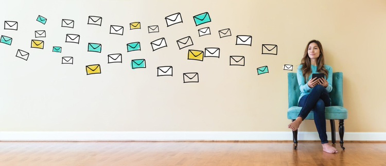 Woman sitting in chair with illustrations of emails coming out