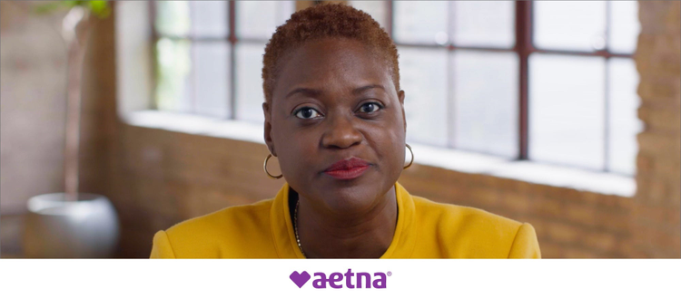 Photograph of woman with the Aetna logo.