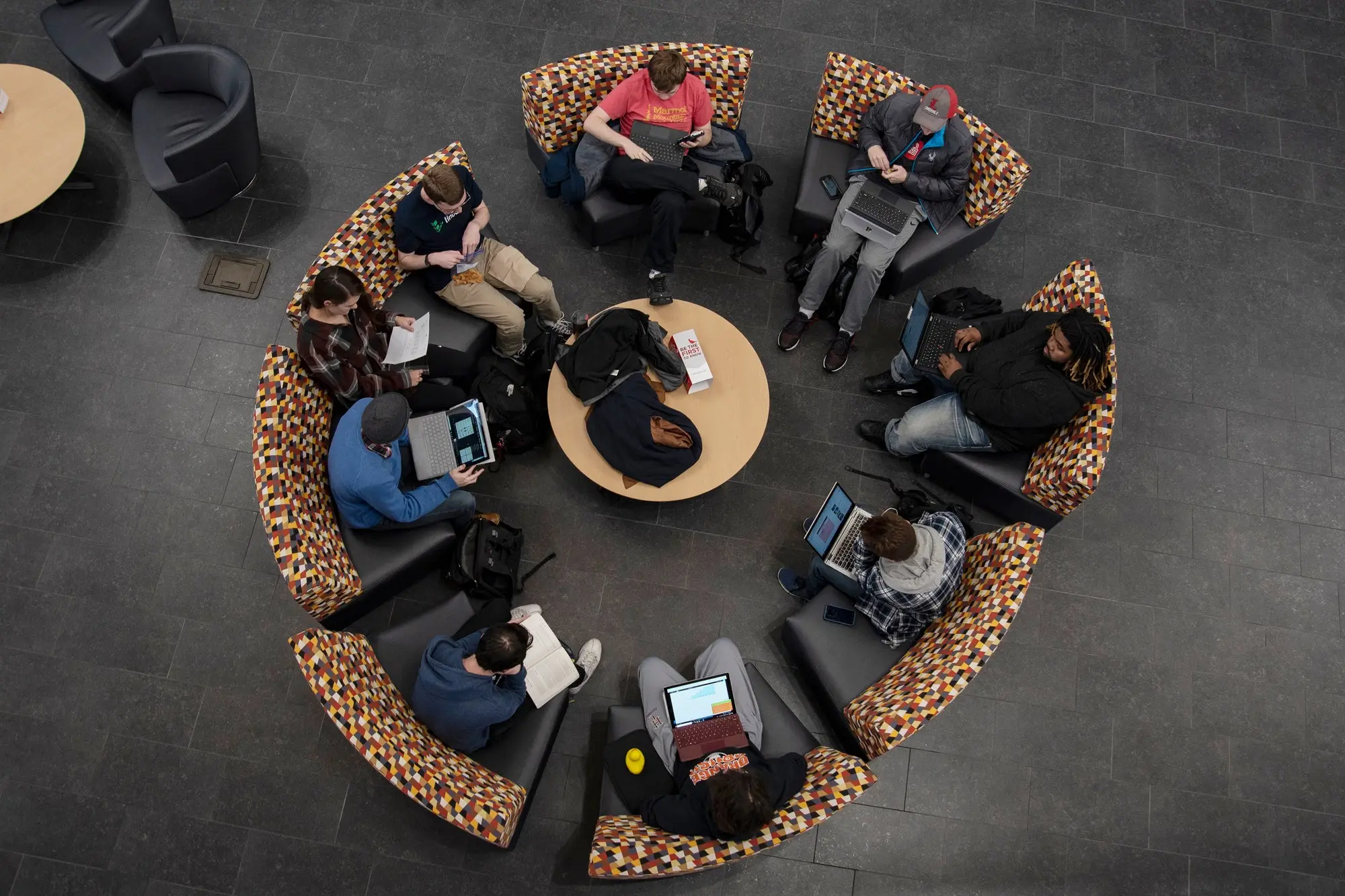 Students gathered in a circle in a common area. 