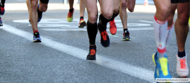 Close up photo of the legs of people running. 