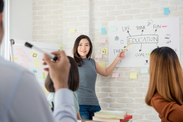 Female college student making a presentation in classroom.