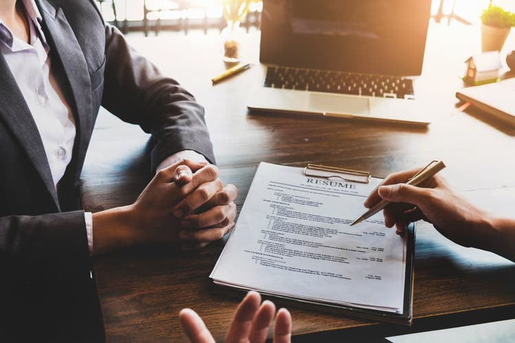 Application for jobs and interviews concept, female is hoping for a resume and recruiter considering application, hr manager making hiring decision.