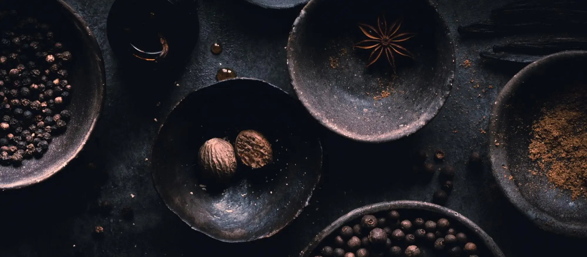 Close up images of dark bowls with food in them. 