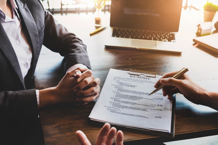 Application for jobs and interviews concept, female is hoping for a resume and recruiter considering application, hr manager making hiring decision.