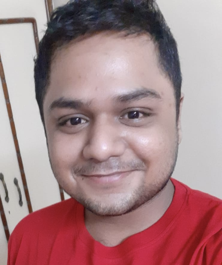 A photo of Kapish Luhariwala. He's wearing a red Adobe t shirt.