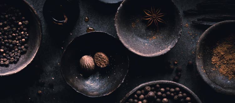 Close up images of dark bowls with food in them.