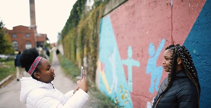 Woman taking a picture of another woman.