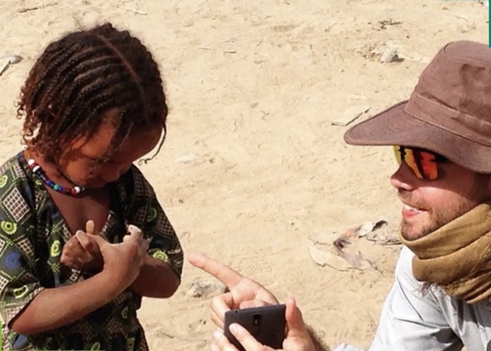 Man showing small child an image.