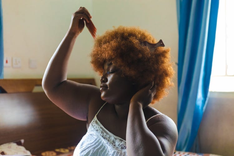 Woman combing her hair. 