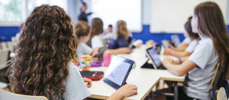 Children in a classroom with ipads