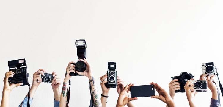 Reportage holding a recorder equipment in a line.