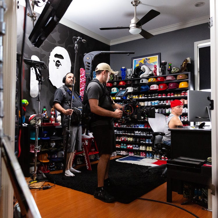 A videographer and boom operator film Ryan Hudson-Peralta as he showcases his workflow for designing in Adobe XD with a mouse.