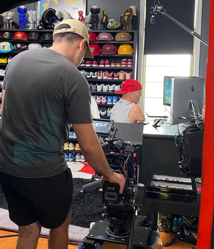 A videographer films Ryan Hudson-Peralta as he showcases his workflow for designing in Adobe XD with a mouse.