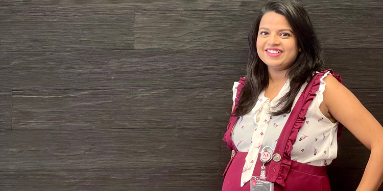 Adobe Senior Software Engineer, Ankita Wankhede. In this photo she is smiling while in an Adobe office.