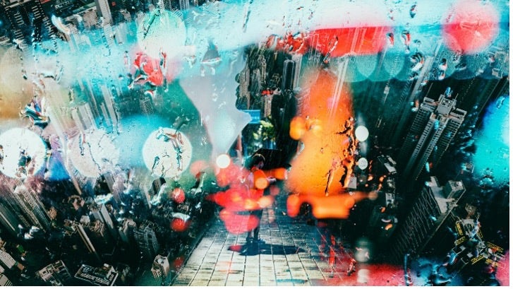 Artwork by Jongwoo Kim: A multiple exposure artwork of the city, overlayed with light fragments and rain.