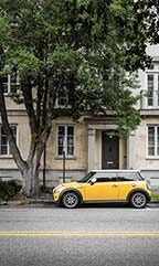 Car in front of apartment in low resolution.