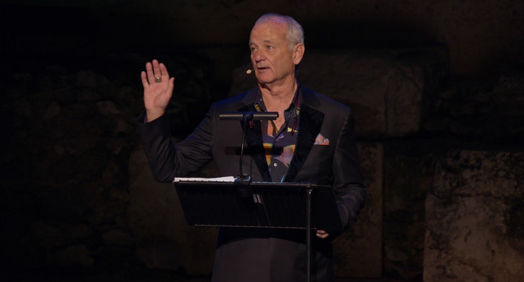 Photograph of Bill Murray at a podium giving a speech.