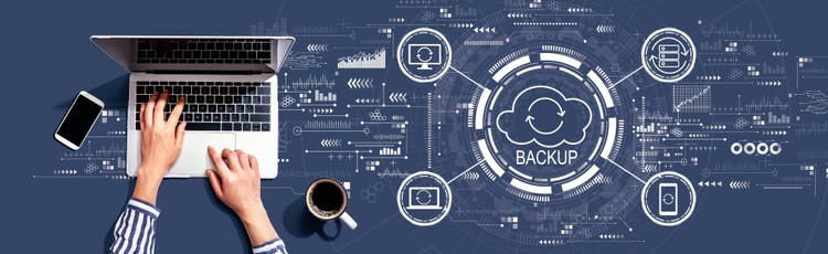 Backup concept with person using a laptop computer,