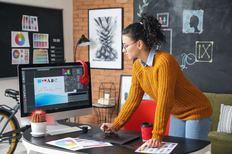 Young female designer working in office.