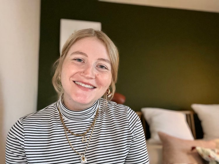 Adobe employee Daisy Rendall smiling in her home office.
