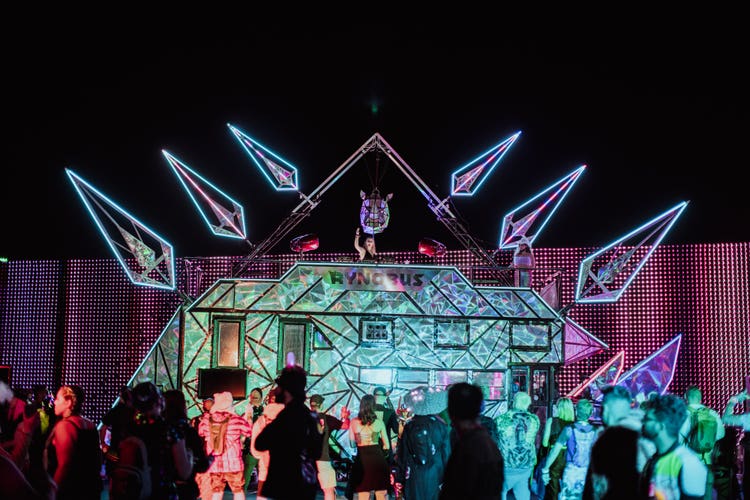 Stage with a DJ at a music festival.