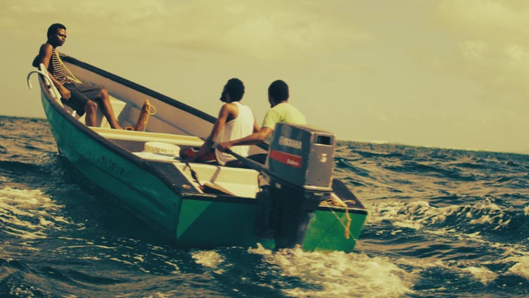 Image of three men on a boat.