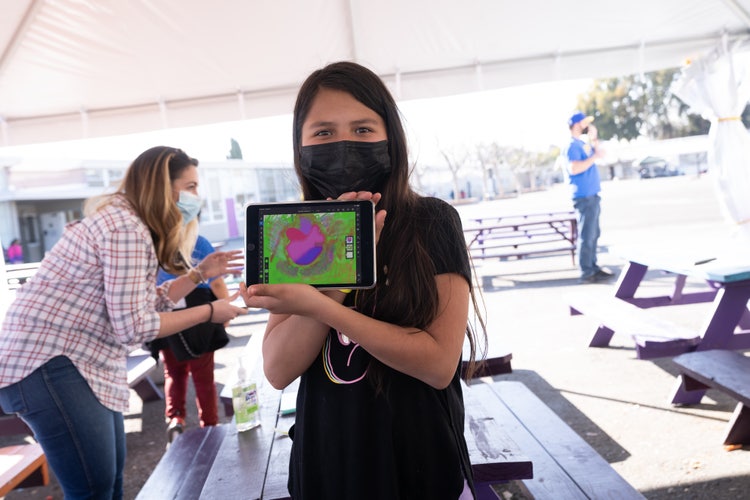 Little girl showcasing her work in Adobe Fresco. 