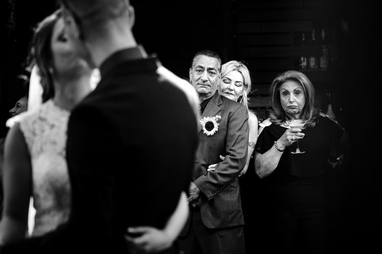 The parents soaking up the moment and the guest sipping martini.