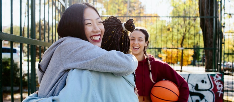 Women friends hugging.
