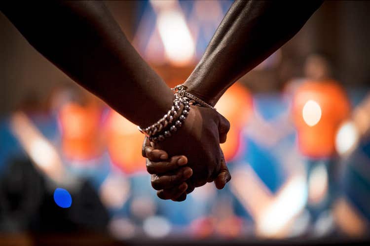 Image of hands being held