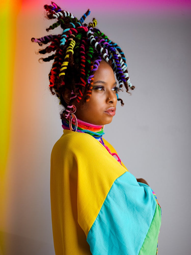 Self portrait of Chinelle Rojas with colorful locs, taken with a Fijifilm GFX50S II.