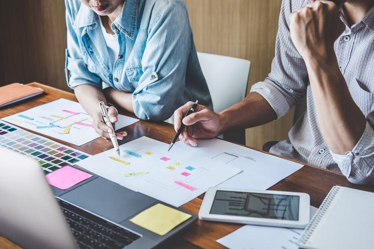 User experience designers at a table working together.