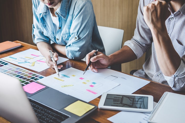 User experience designers at a table working together.