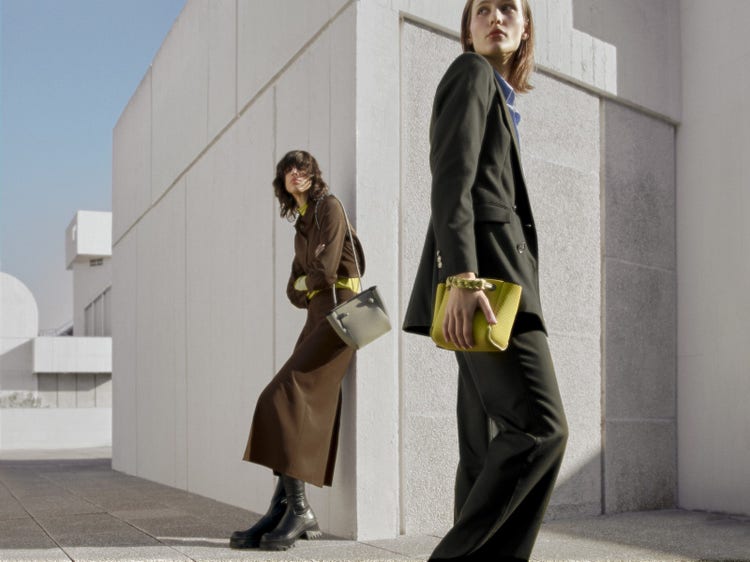 State of Escape Two models holding State of Escape bags on a rooftop