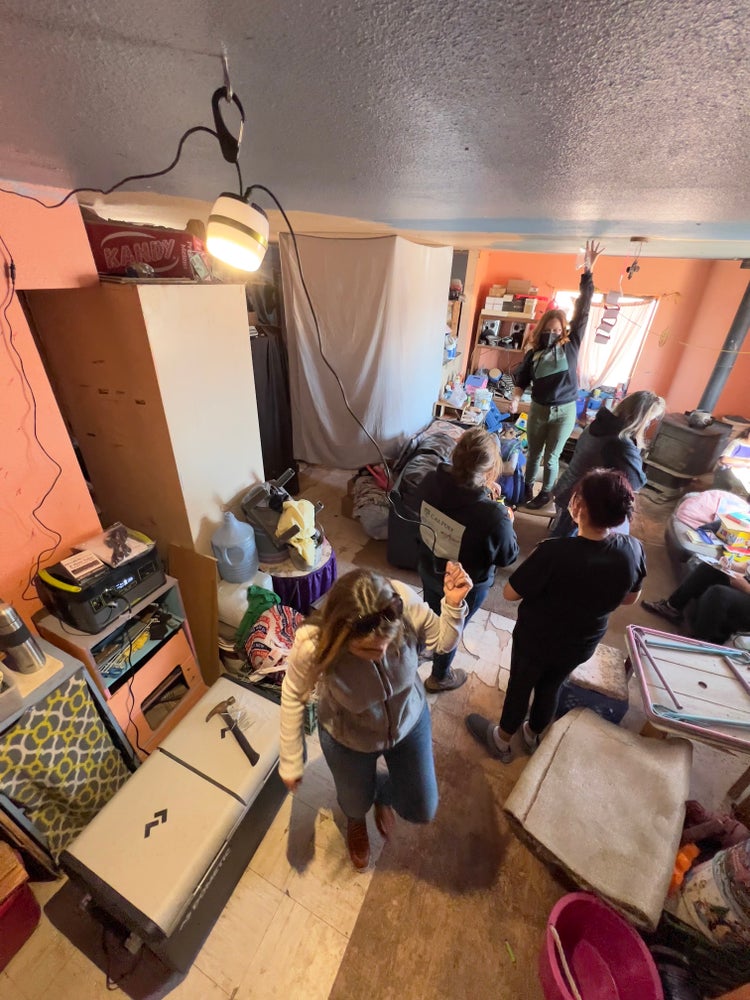 Photograph by Mylo Fowler of a group of people installing solar panels and electricity on the Navajo Reservation