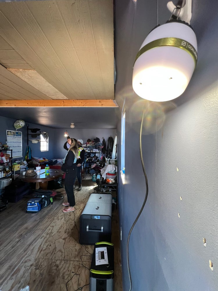 Photograph by Mylo Fowler of a group of people installing solar panels and electricity on the Navajo Reservation