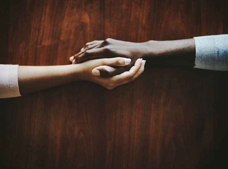 Two hands holding each other