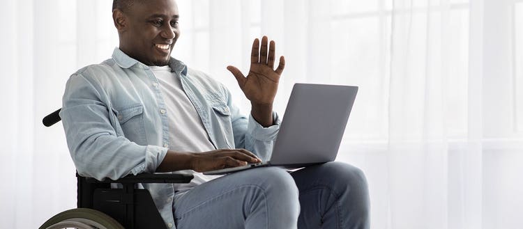 Man in a wheelchair on a laptop.