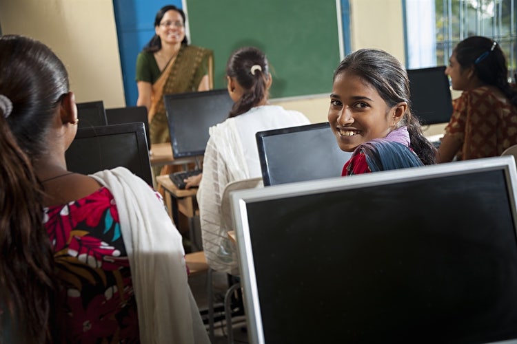 Young girl in classroom on a computer