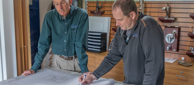 Two men looking at blueprints.